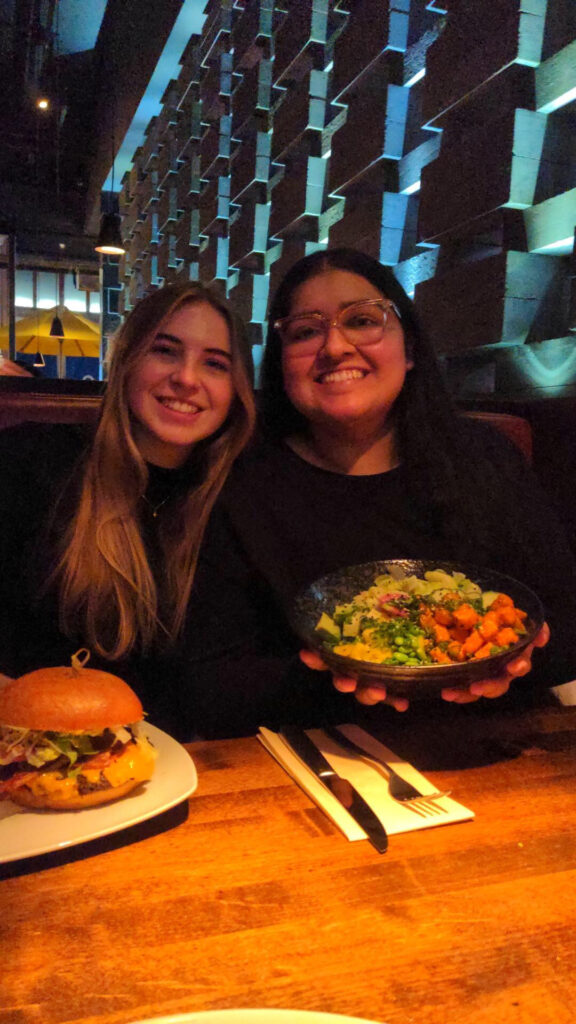 This picture is of me and my friend, Lauren, at Cactus Club with some of our favourite dishes to get from there. This picture might be the inspiration for a dish I could re-create in the future. I am holding a spicy tofu bowl that has tofu, avocado, brown rice, lettuce, mango, and ginger. Lauren has a burger with the classic toppings of lettuce, tomato, and cheese.