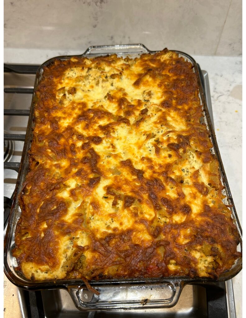 Pasta in a glass dish that has been baked with cheese.
